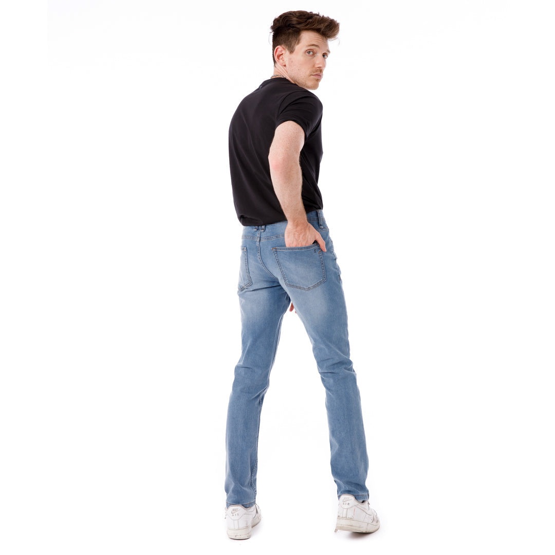 Man wearing black t-shirt and light blue skinny fit jeans, shown from back angle.