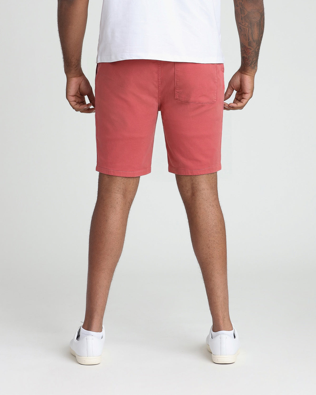 Nantucket red athletic fit shorts with back pocket, worn with white t-shirt and sneakers.