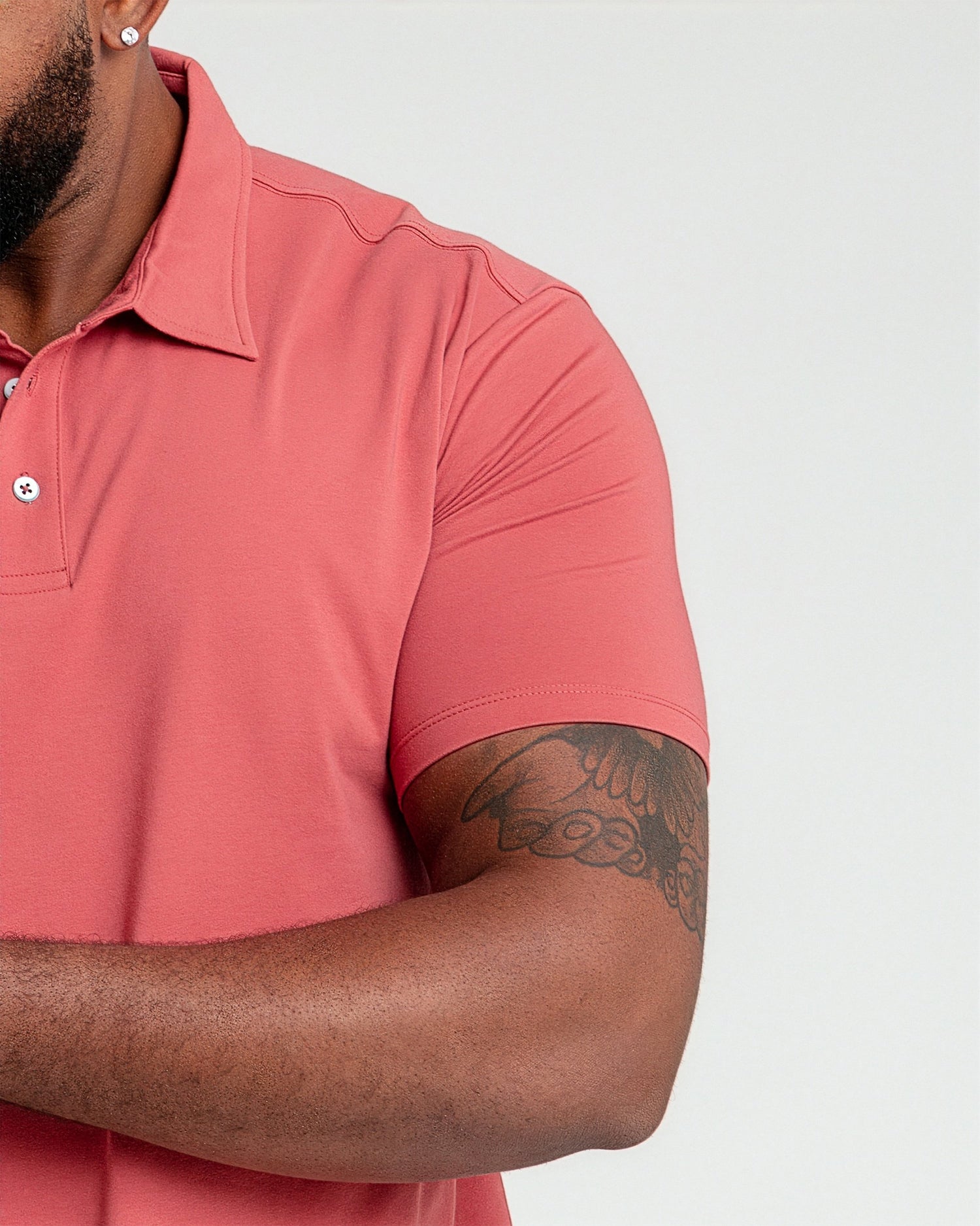 Nantucket red polo shirt with collar and button placket displayed on a person.