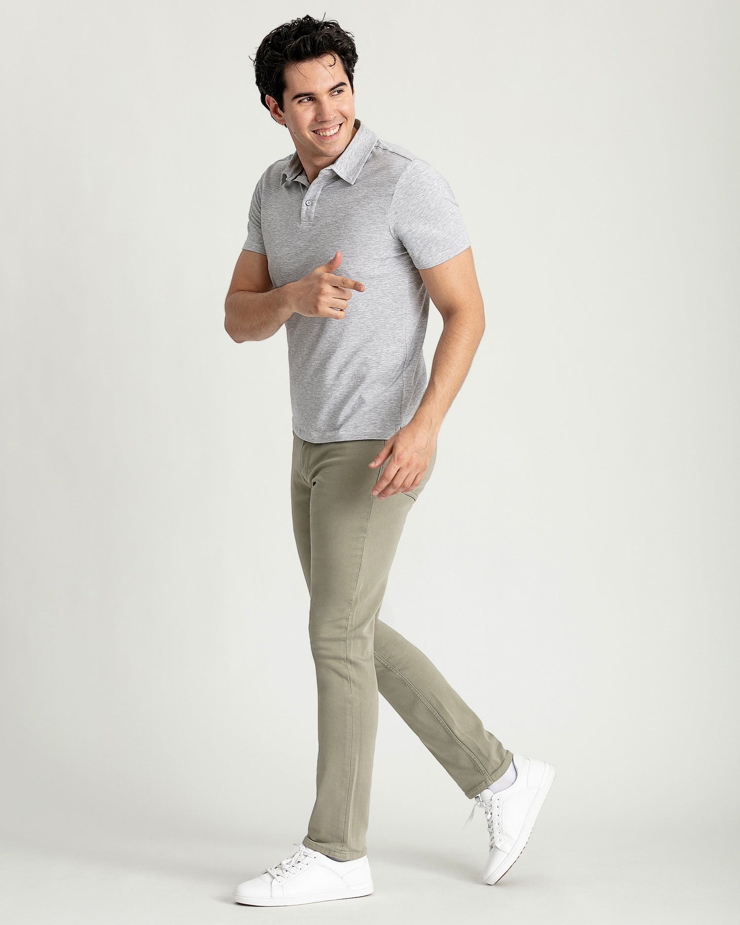 Man wearing heather grey short-sleeve polo shirt with white button placket and khaki pants.