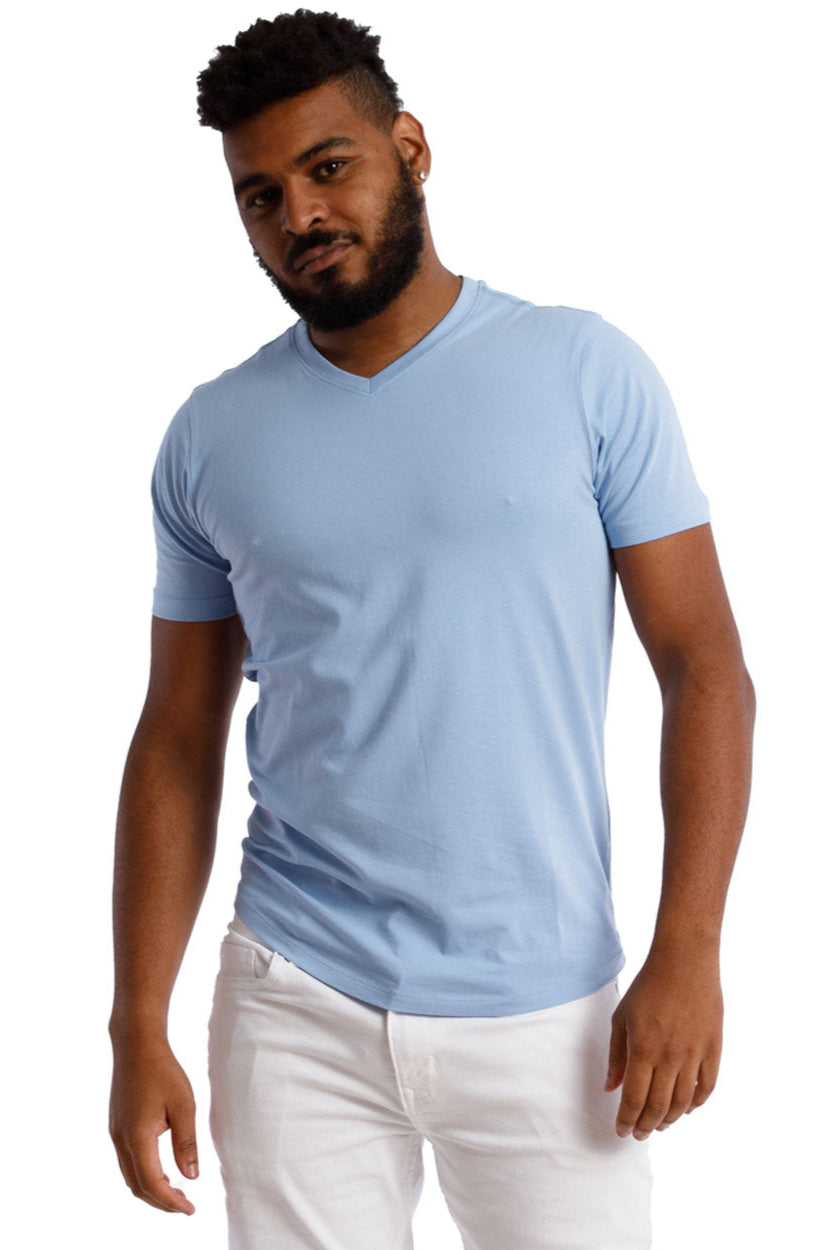 Man in Organic V-Neck T-Shirt 3 Pack / Americana, wearing a light blue, short-sleeve V-neck tee and white pants, showcasing relaxed fit and comfort.