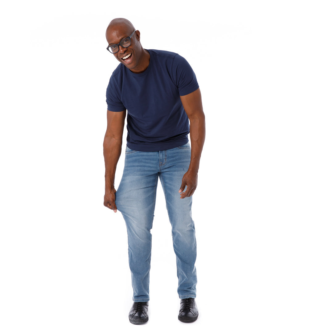 Man wearing navy short-sleeve t-shirt and light blue athletic fit jeans.