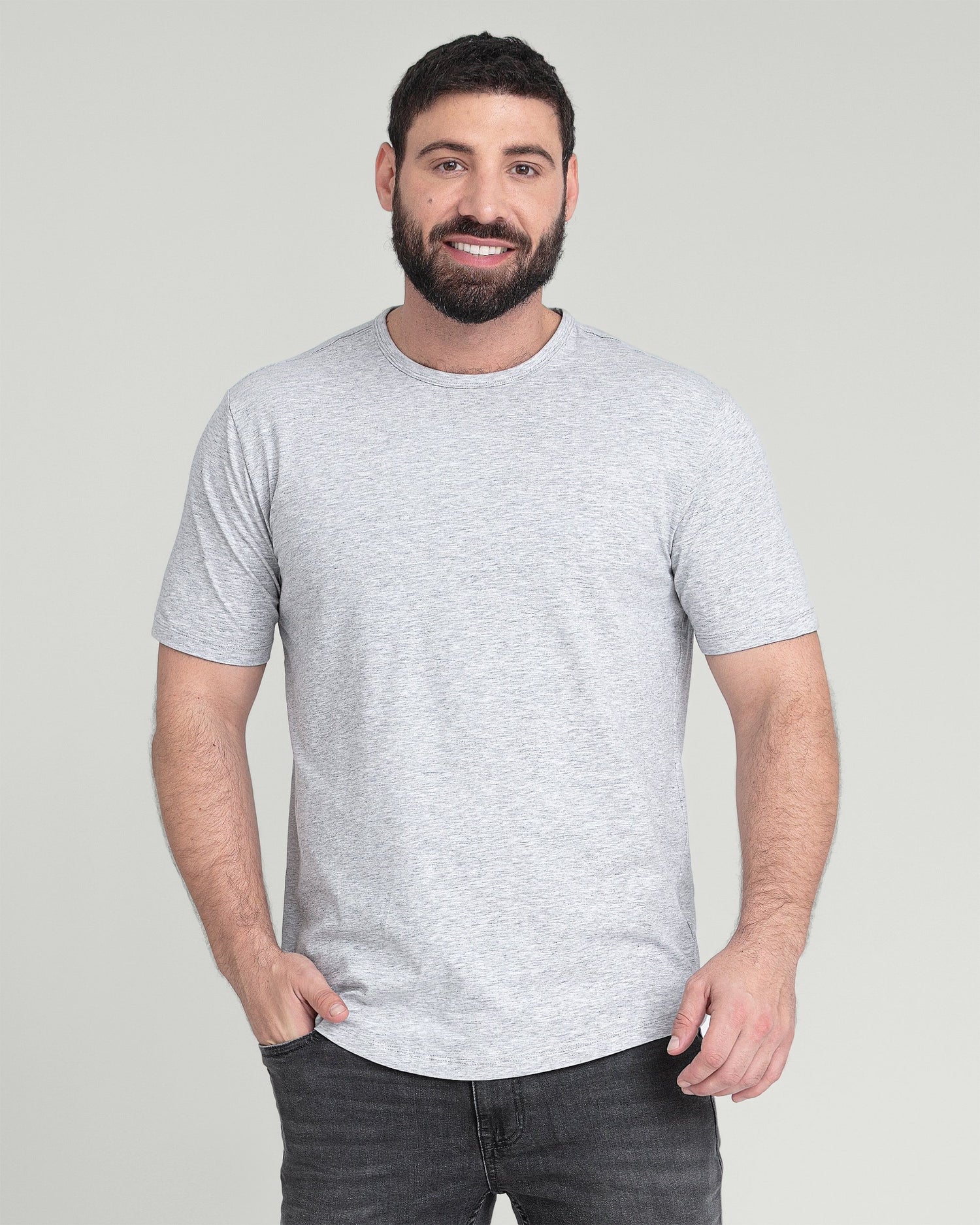 Man wearing light gray crew neck t-shirt with short sleeves and dark jeans.