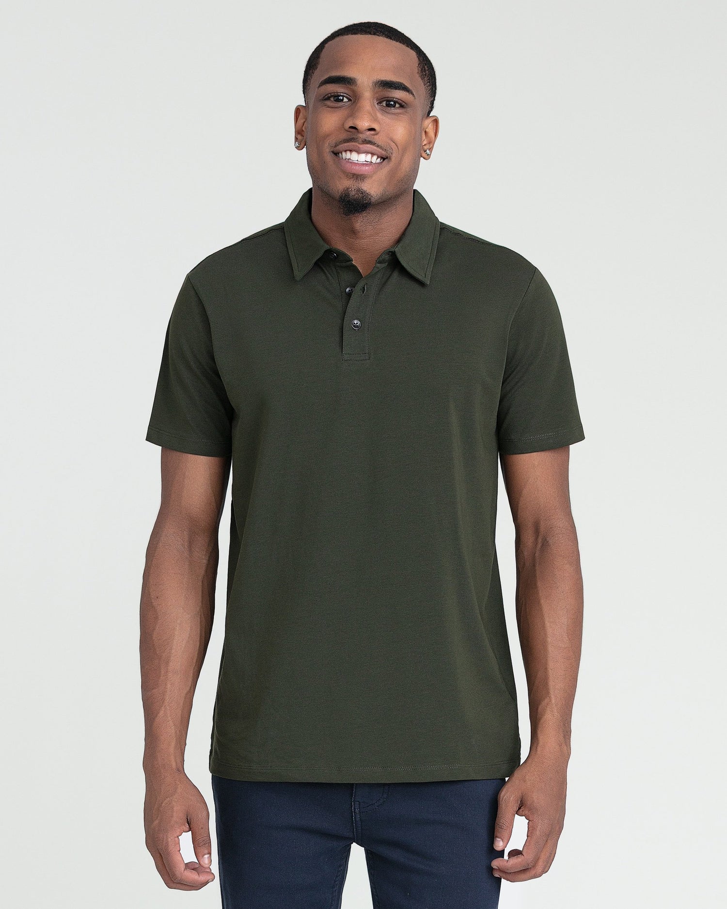 Olive green short-sleeve polo shirt with button placket, displayed on a man wearing navy pants.