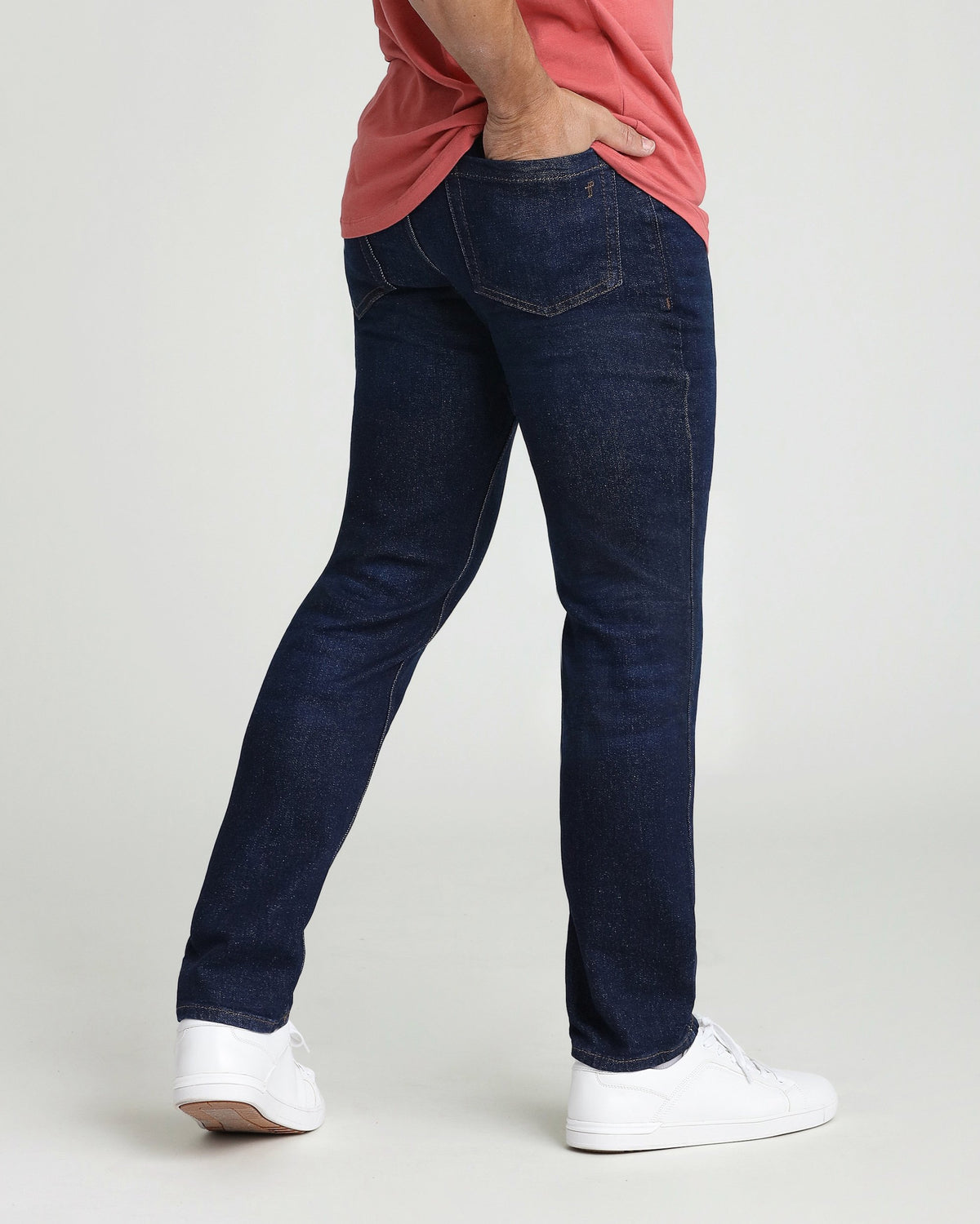 Dark blue denim jeans with straight leg fit and visible stitching detail on back pocket.