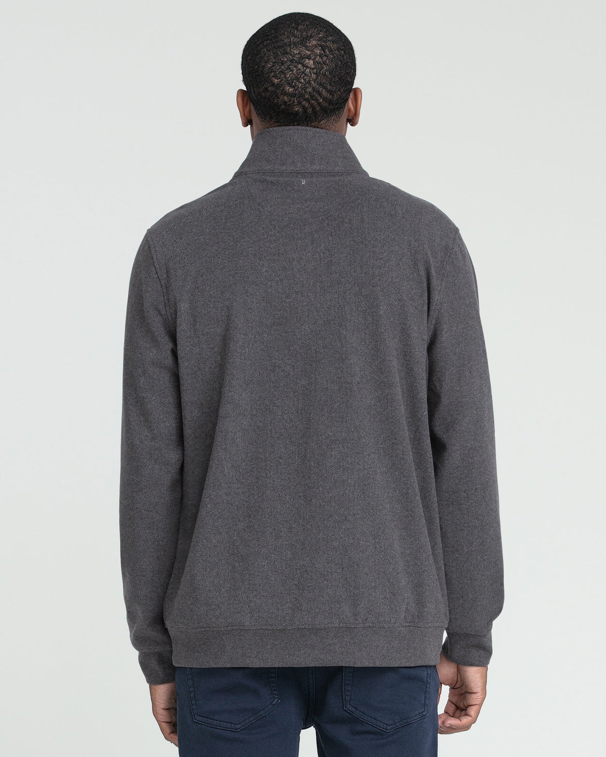 Charcoal heather quarter zip pullover shown from back, worn with navy pants.