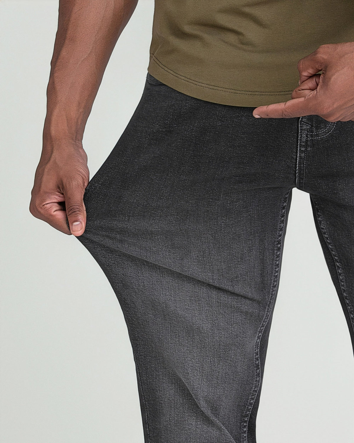 Man wearing grey Axel slim thick fit jeans with olive green shirt, showing fabric texture and fit.