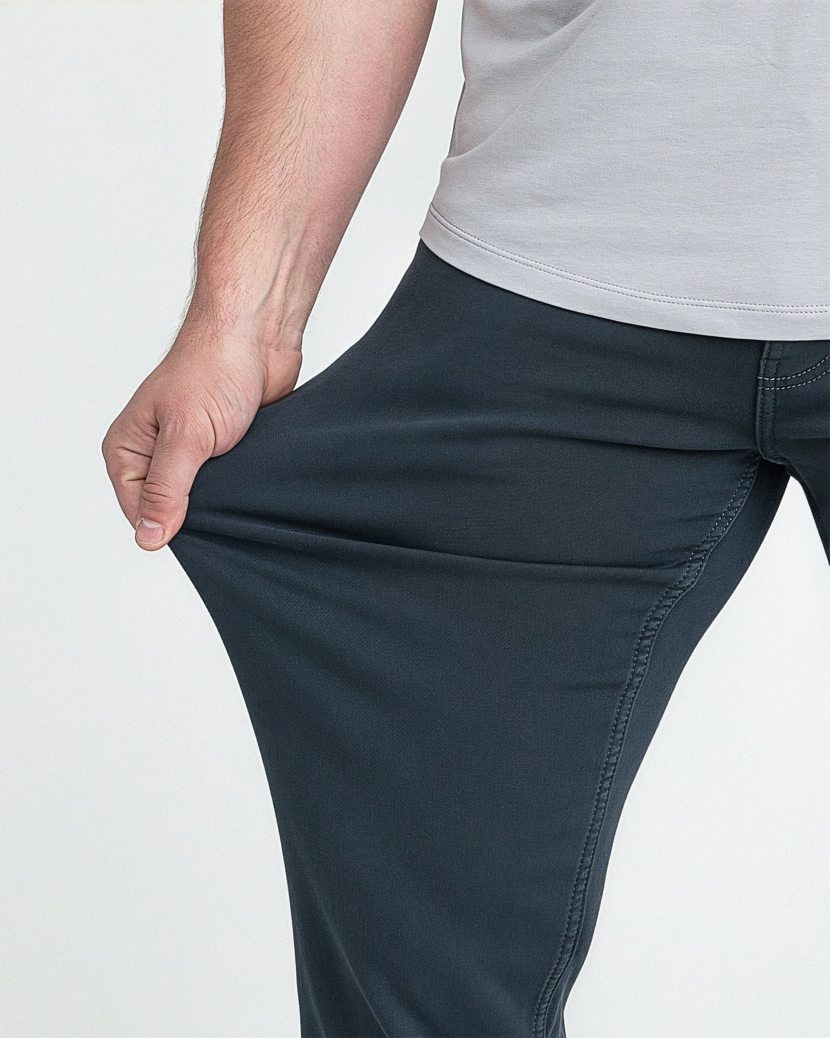 Man wearing slate gray athletic fit pants with gray t-shirt, showing fit at hip and thigh.