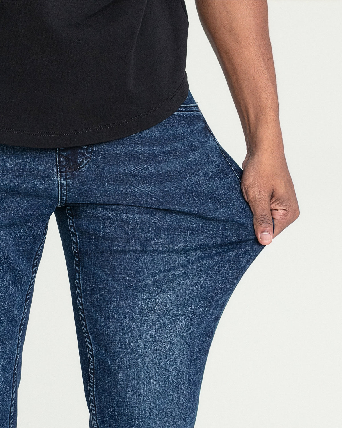 Dark blue bootcut jeans with visible stitching detail on thigh and leg.