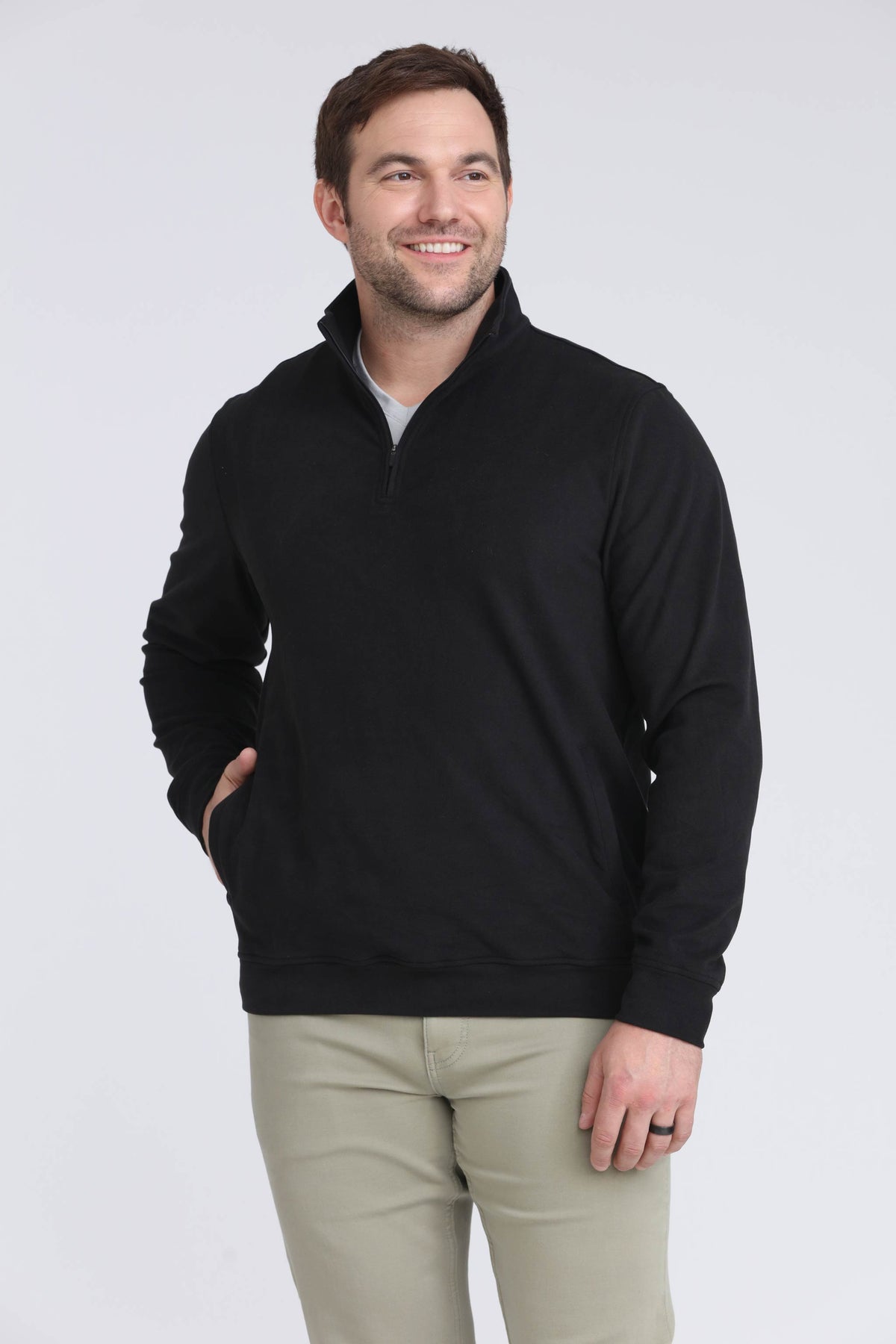 Black quarter zip pullover with gray undershirt, worn with tan pants and front hand pockets visible.